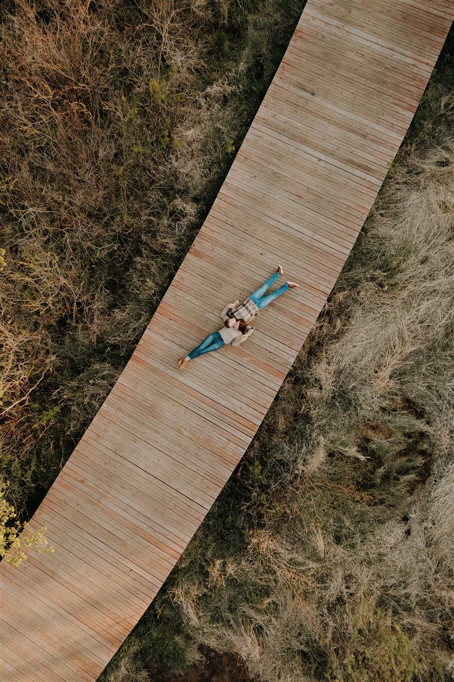 Aerial engagement session on a boardwalk