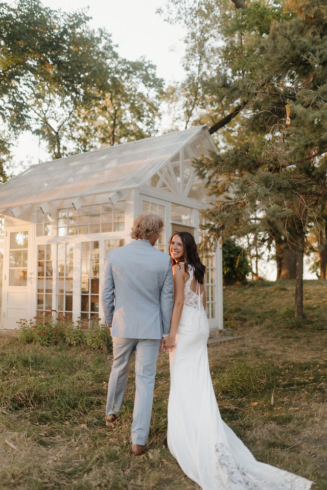 Couple walking to the glass greenhouse at South Glen Farm