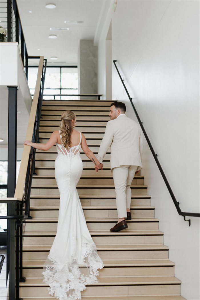 Bride and groom on the staircase at Catalyst by Nature Link
