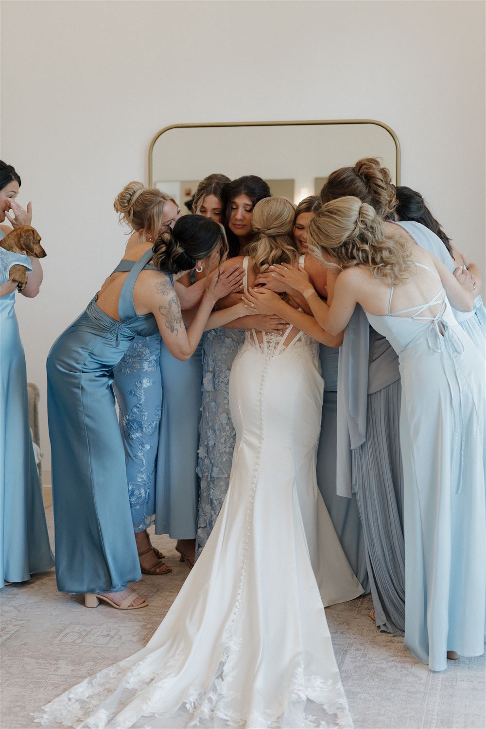 Bride and bridesmaids embracing